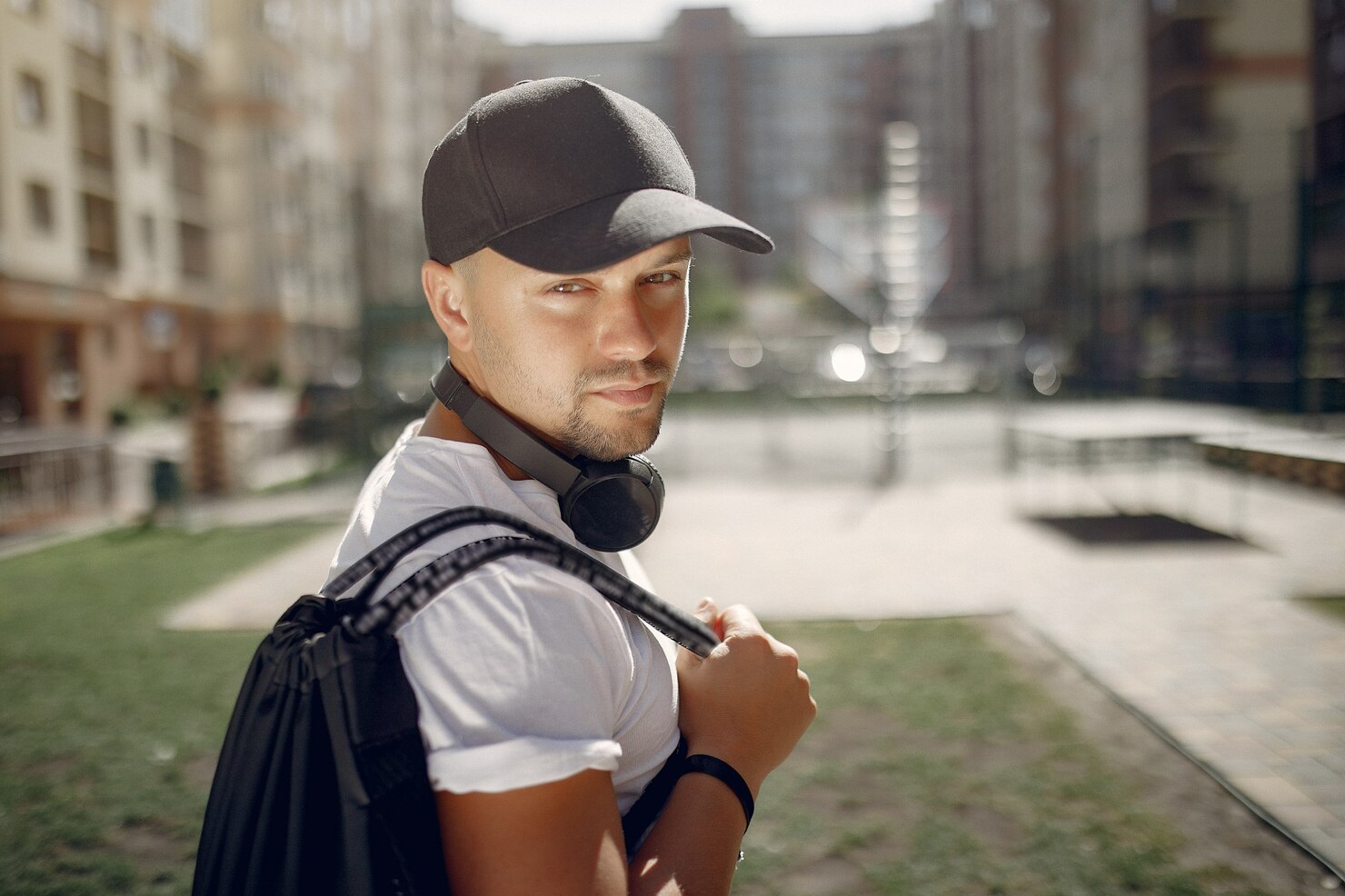 handsome-man-standing-park-with-headphones_1157-30680